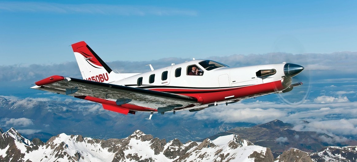 Daher TBM 850 flying over snowy mountains