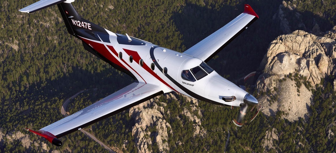 Pilatus PC-12 NG flying over mountains