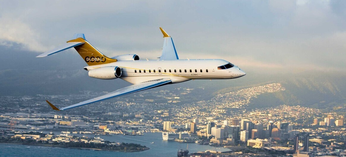 Bombardier Global 6000 flying over city