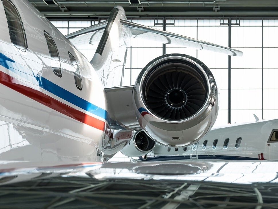 Private jet parked in a maintenance hangar