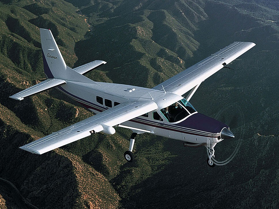 Cessna Caravan flying over mountains